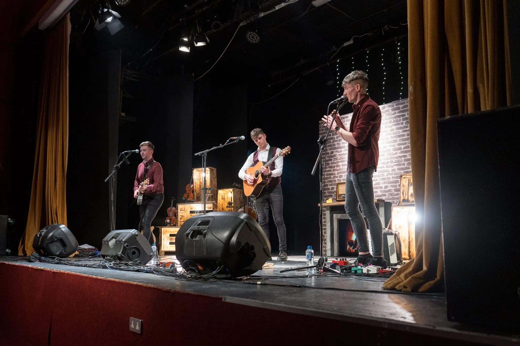 The Kings of Connaught on a theatre stage, lit in amber
